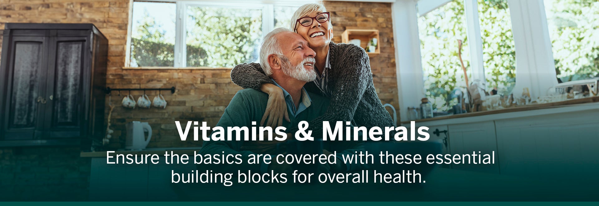 Wife and husband hugging and smiling with the text written Vitamins & Minerals. Ensure the basics are covered with these essential building blocks for overall health.