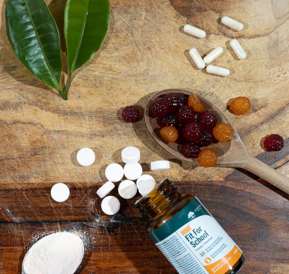 HMF Fit For School supplements on a counter next to gummy vitamins.